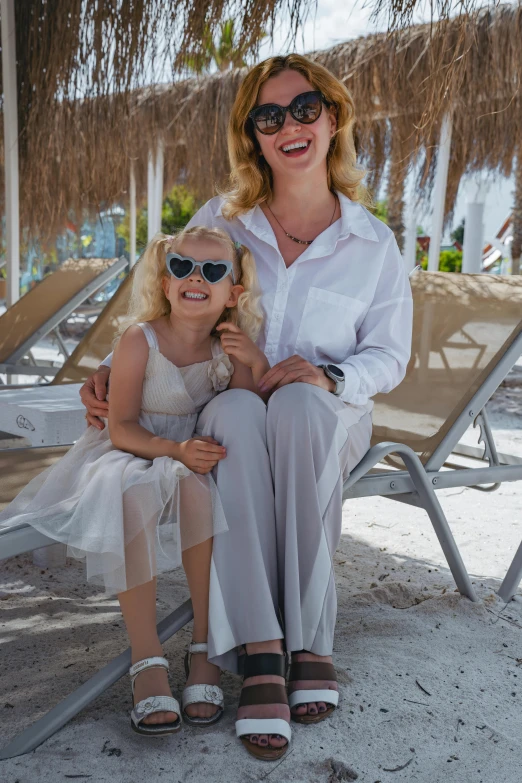 a woman sitting next to a  wearing sunglasses