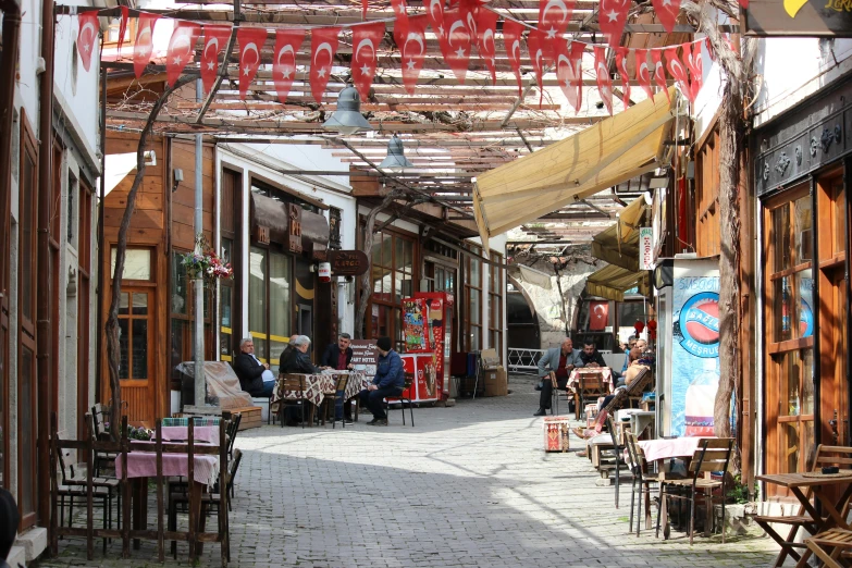 a view down a cobblestone walkway into a cafe