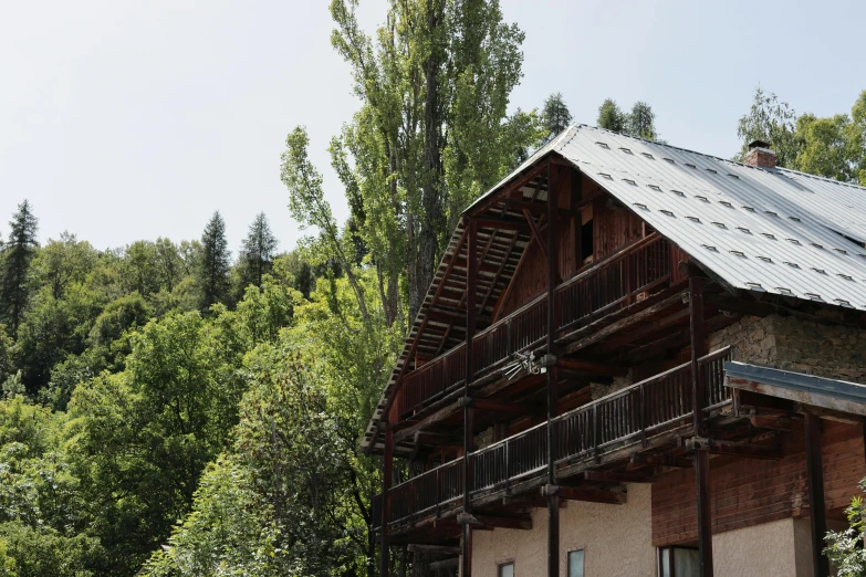 a log cabin in a forested area near trees