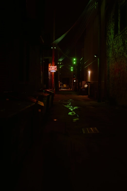 an alley way at night with street lights