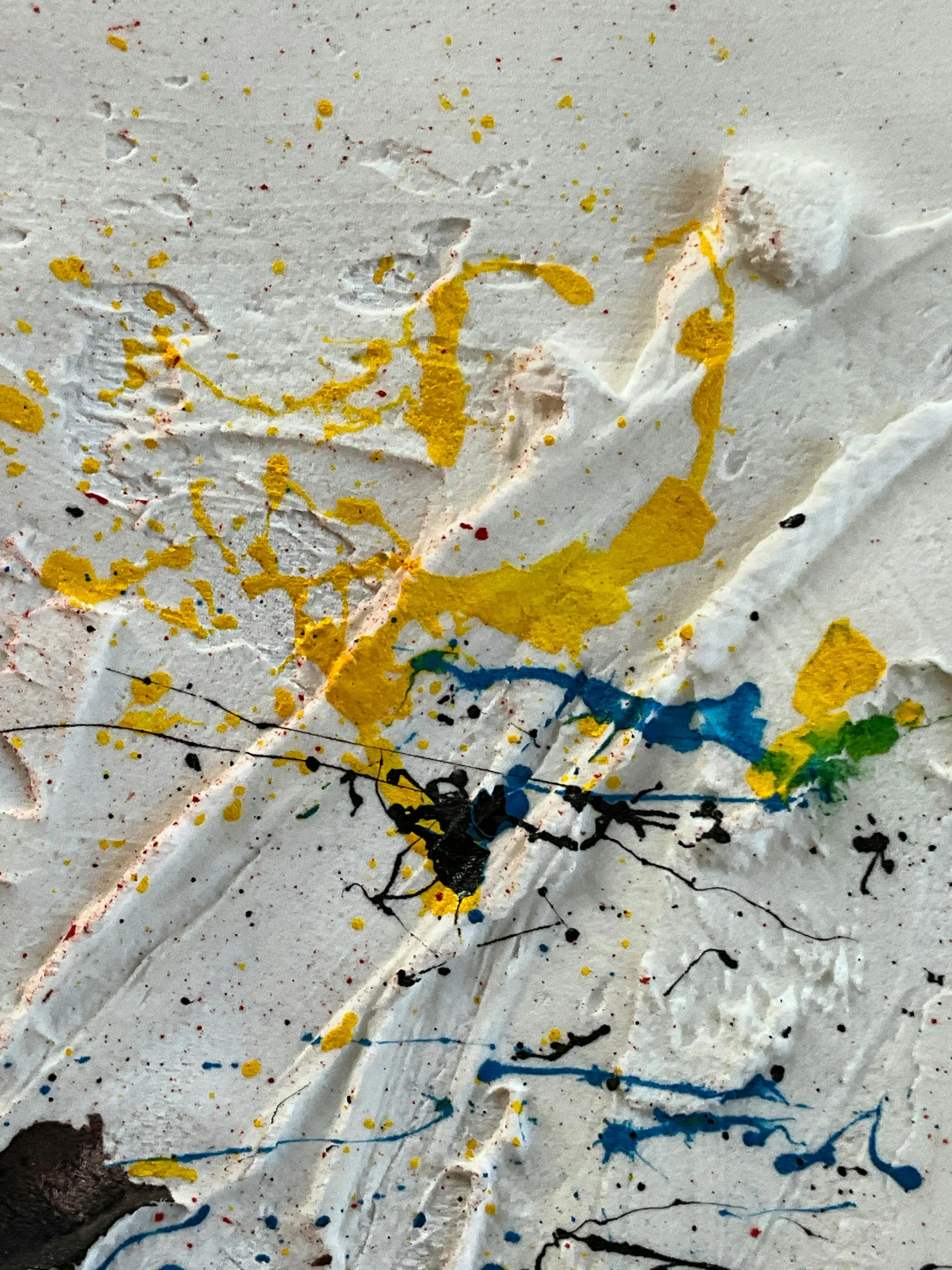 a multicolored piece of paint on paper