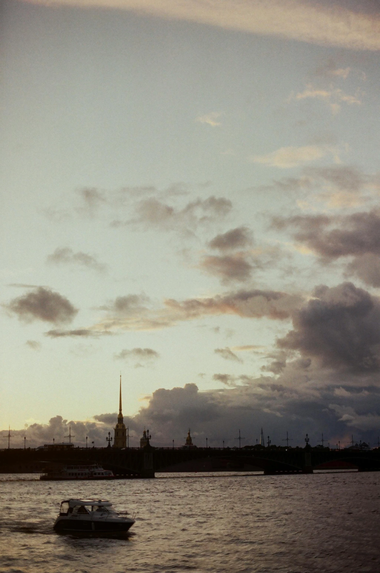 boat in a river at dusk in a city