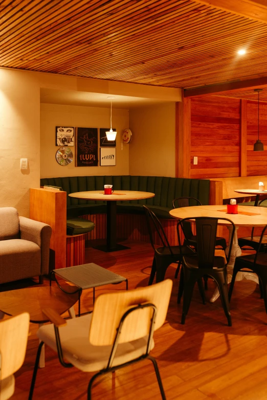 tables and chairs arranged around an empty coffee table