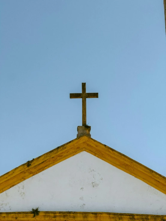 a cross is above the roof of a church