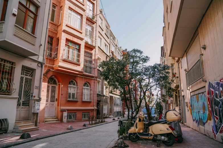 some small buildings are lined with vespas