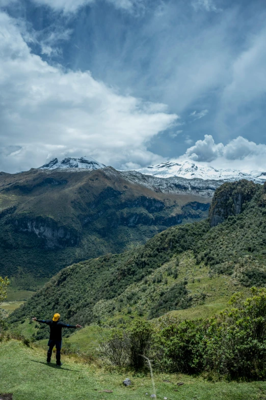 a man is standing in the distance in front of mountains