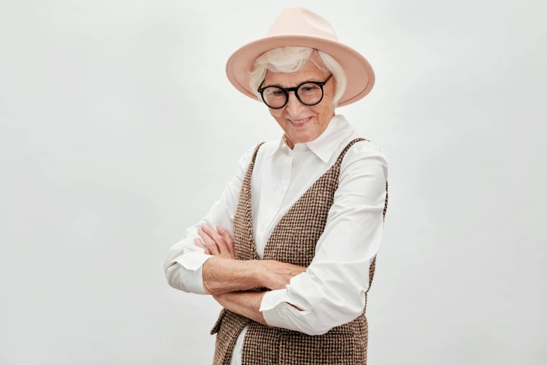 an older woman in a hat with glasses on her head