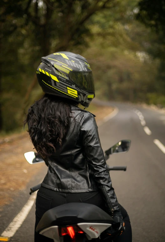 a woman sitting on the back of a motorcycle