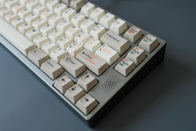 a white, grey and red computer keyboard