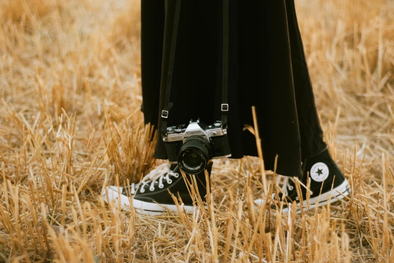 an image of someone wearing a black converse