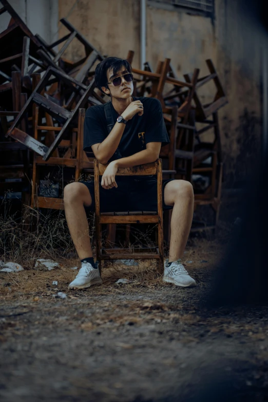 a man sitting in a chair in front of debris