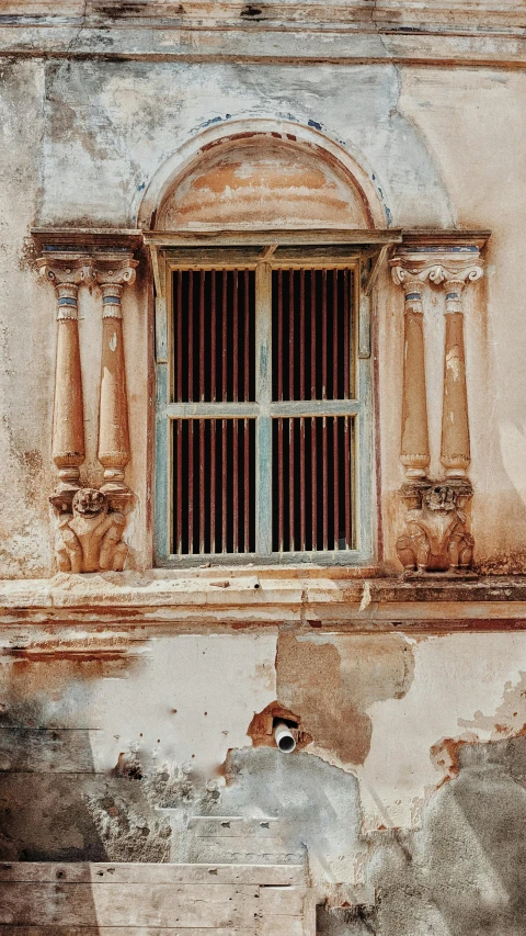 the small wooden bench is in front of the window