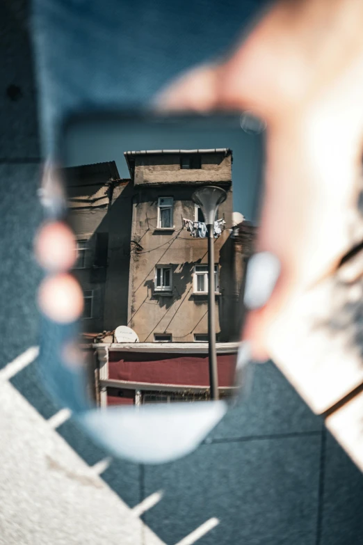 a view from a mirror shows the reflection of a building