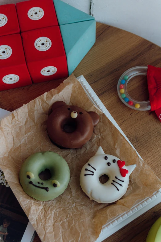 three donuts with different designs on top of the table