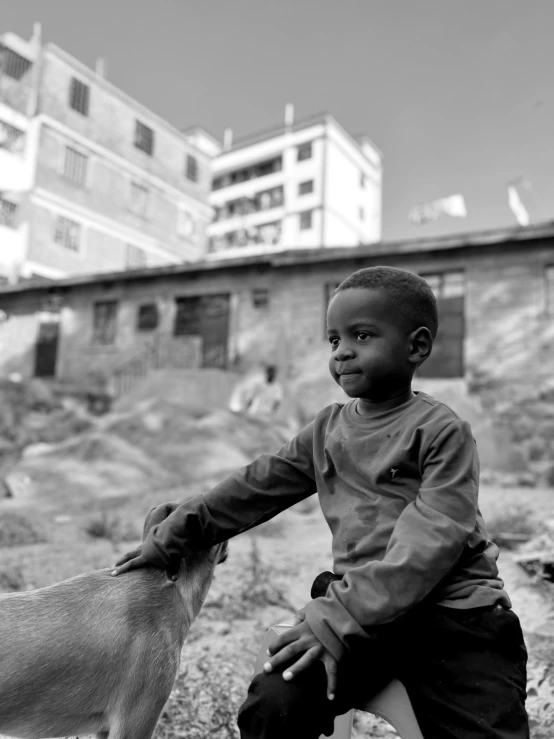 black and white image of boy with goat