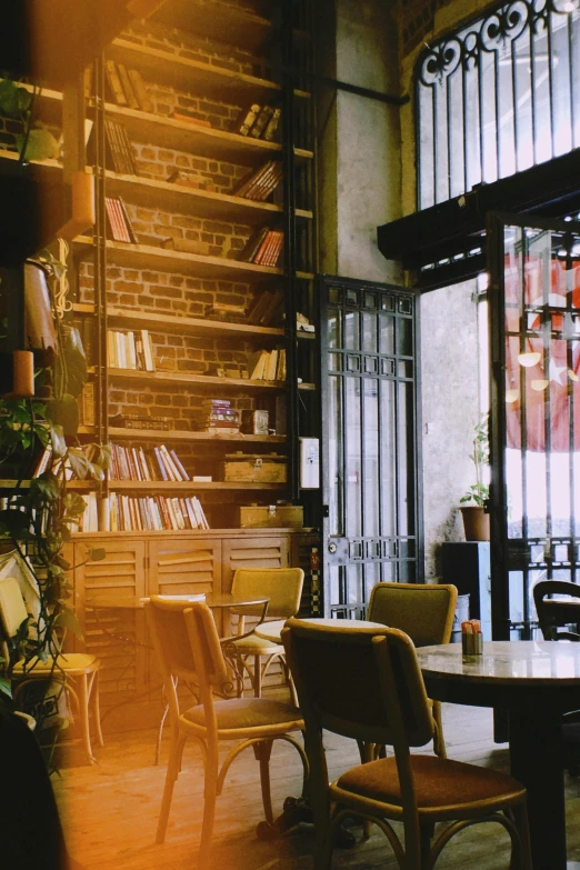 a room filled with lots of books next to windows