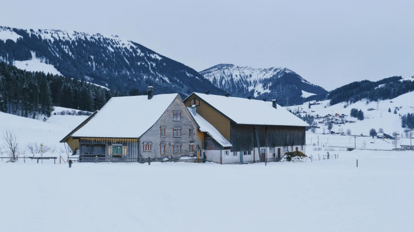 the building is next to a snowy mountain