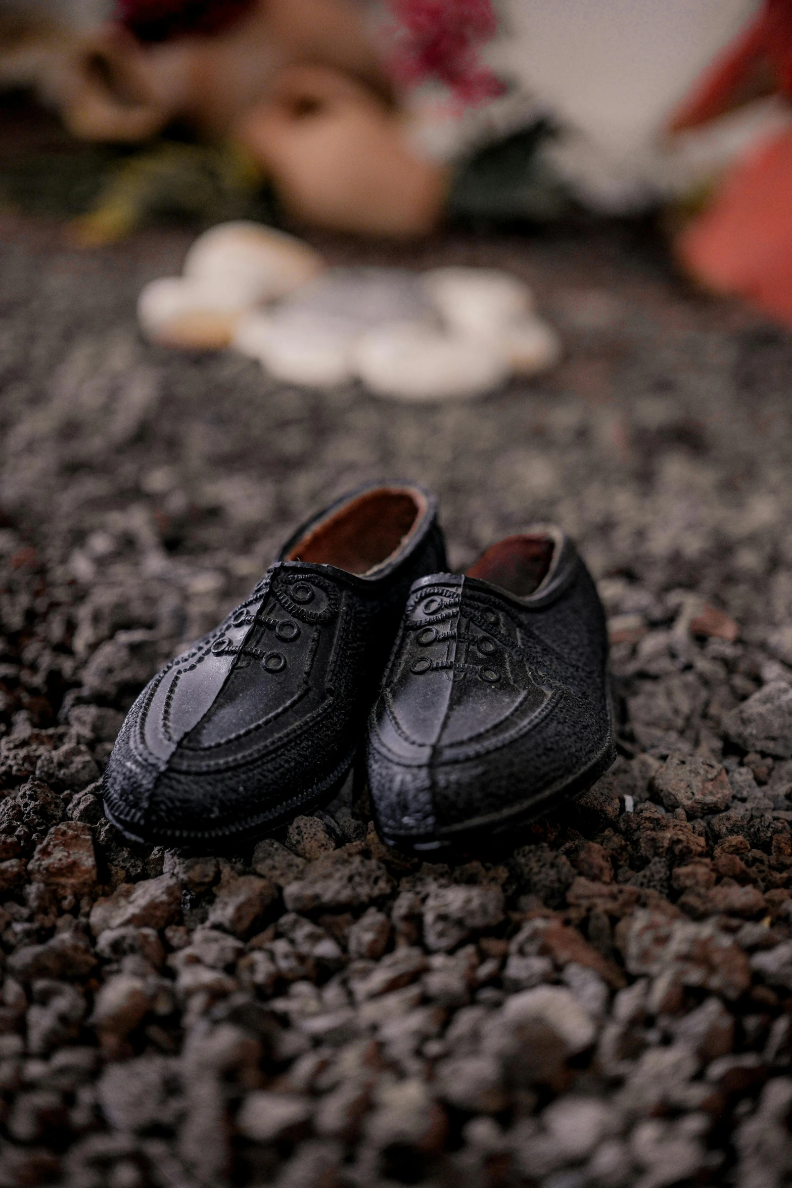 a pair of shoes that are on some pebble