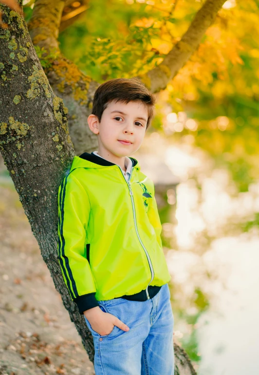 a  stands in front of the tree by the river