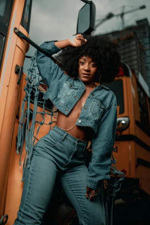 a beautiful woman standing in front of a bus