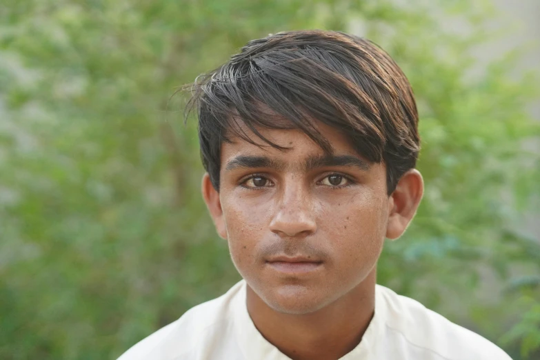 a young man with brown eyes and brown shirt