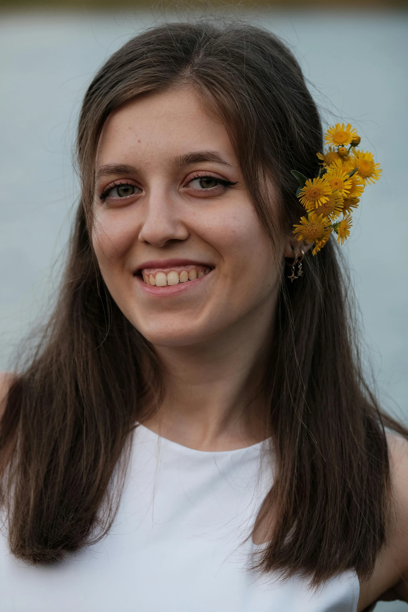 a close up of a person with a flower in her hair