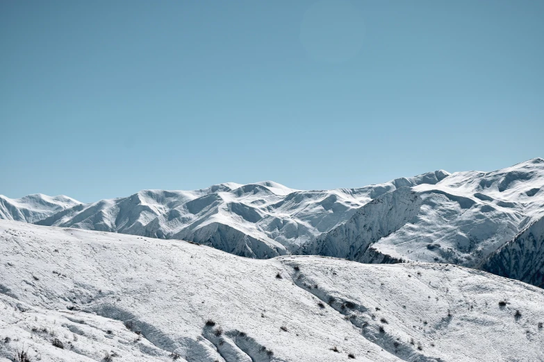 some skiers are going up a mountain in a nice snow scene