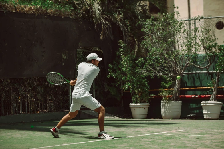 the man is about to hit the ball in a tennis game