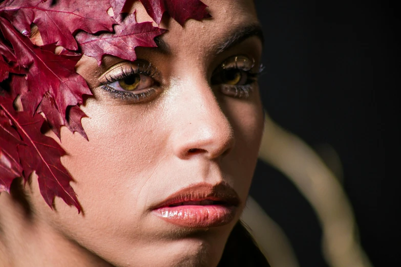 a woman with leafy makeup poses for the camera