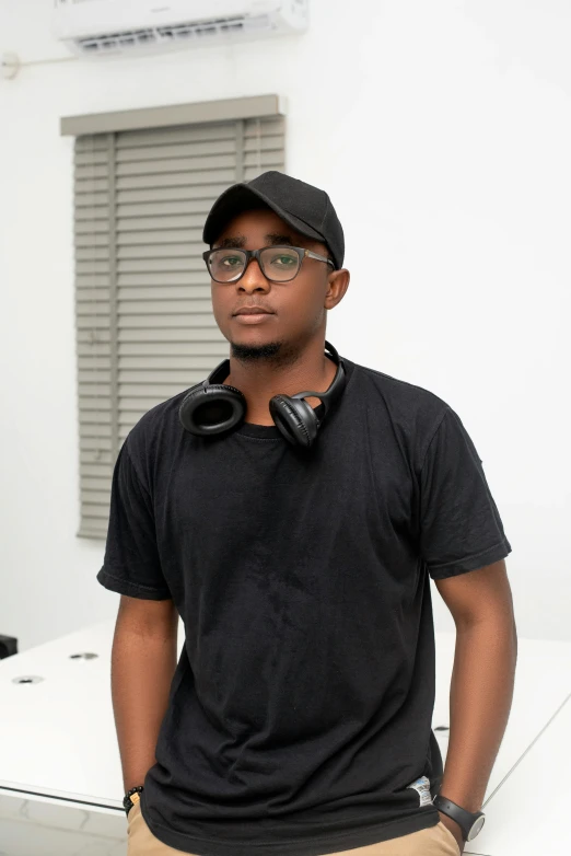 an african american man wearing a black hat and earbuds