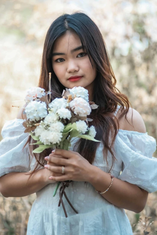 young woman holding a bouquet of flowers