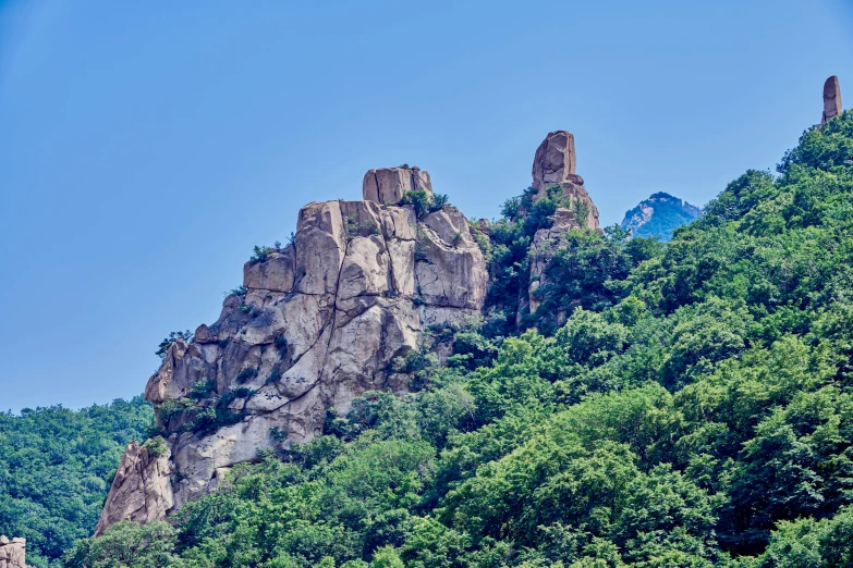 a blue sky over a rocky mountain side