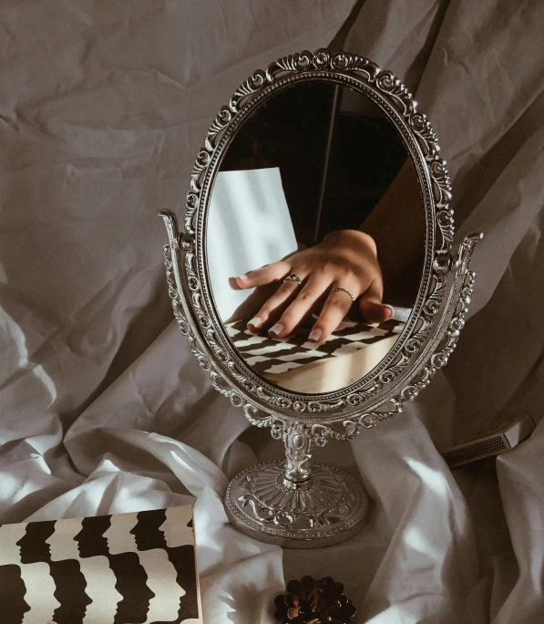 an image of someones hand reflected in the mirror