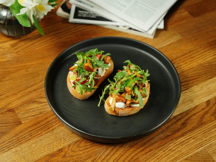 two pieces of bread with various ingredients on it on a plate