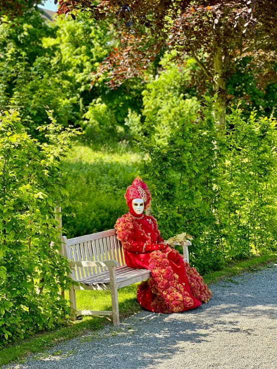 woman in mask sitting on bench in park