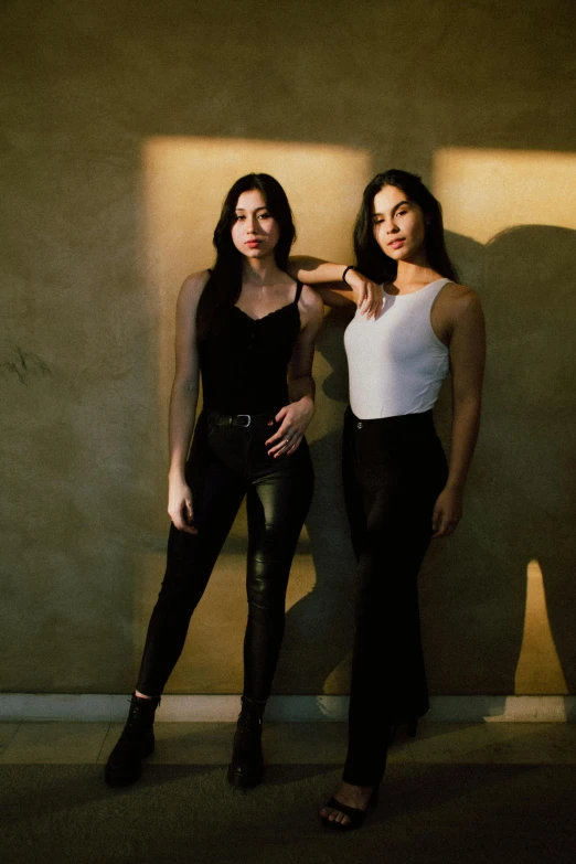 two women in black and white are posing for a po