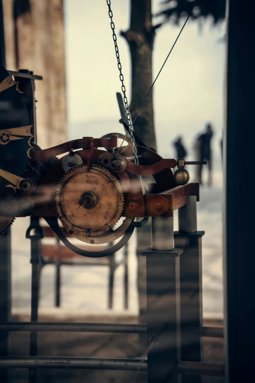 an old clock hanging from a hook