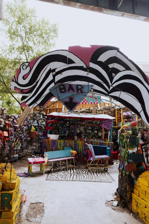 the entrance to a covered market with ze print umbrellas