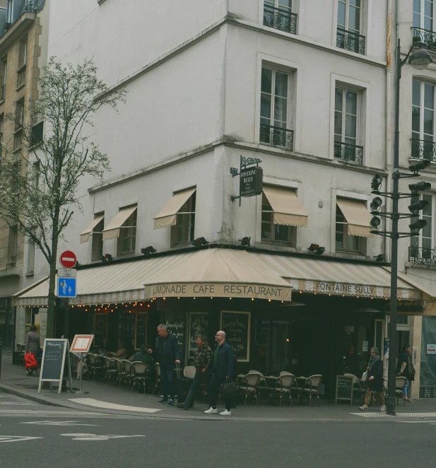 a group of people standing in front of a restaurant