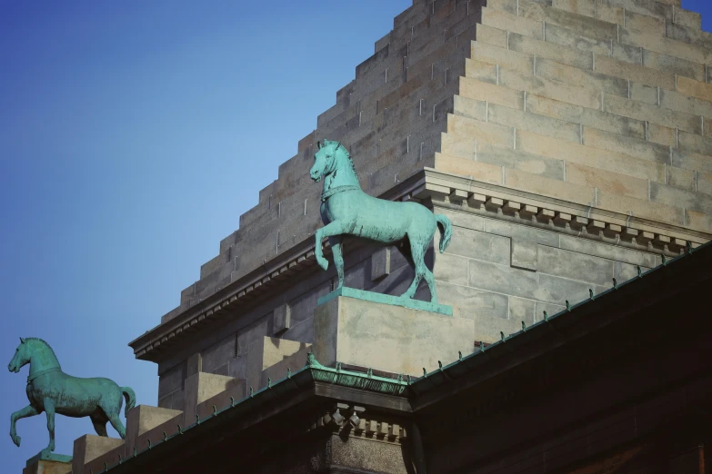 two horses on the top of a building