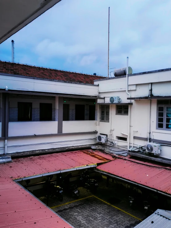 a view from the upper floor of a building with a large room with an open roof