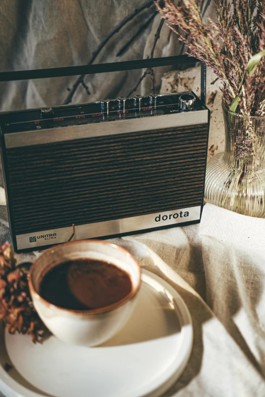 a cup of coffee sitting next to an amp