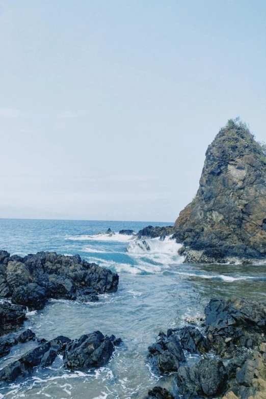 waves come crashing on the coast rocks at a shoreline