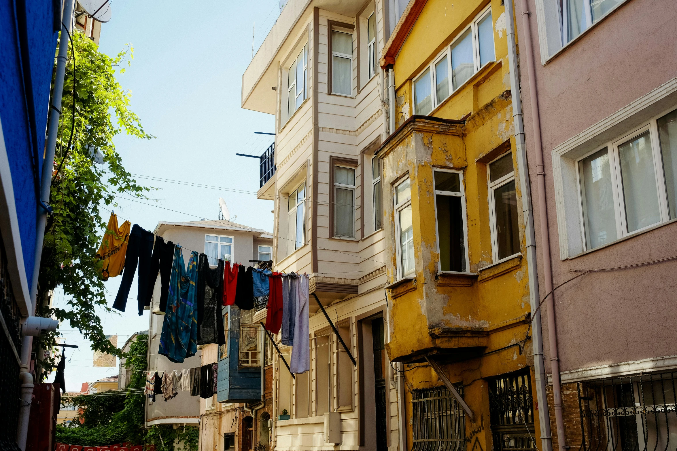 several buildings line the street in front of a clothes line