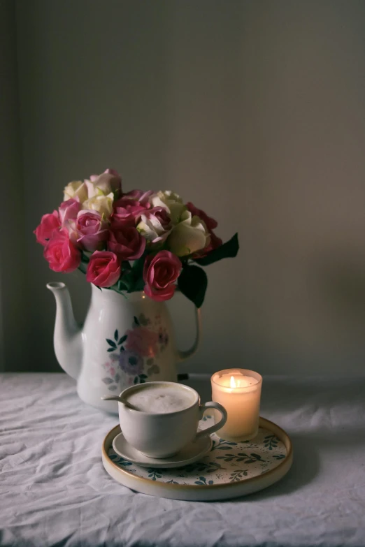 a tea set with flowers is pictured in this pograph