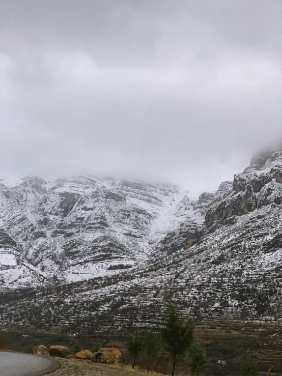 the mountains are covered in snow and grey