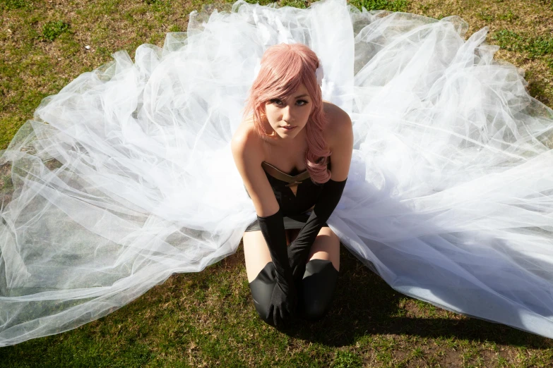 a woman wearing black is posing in front of a wedding gown