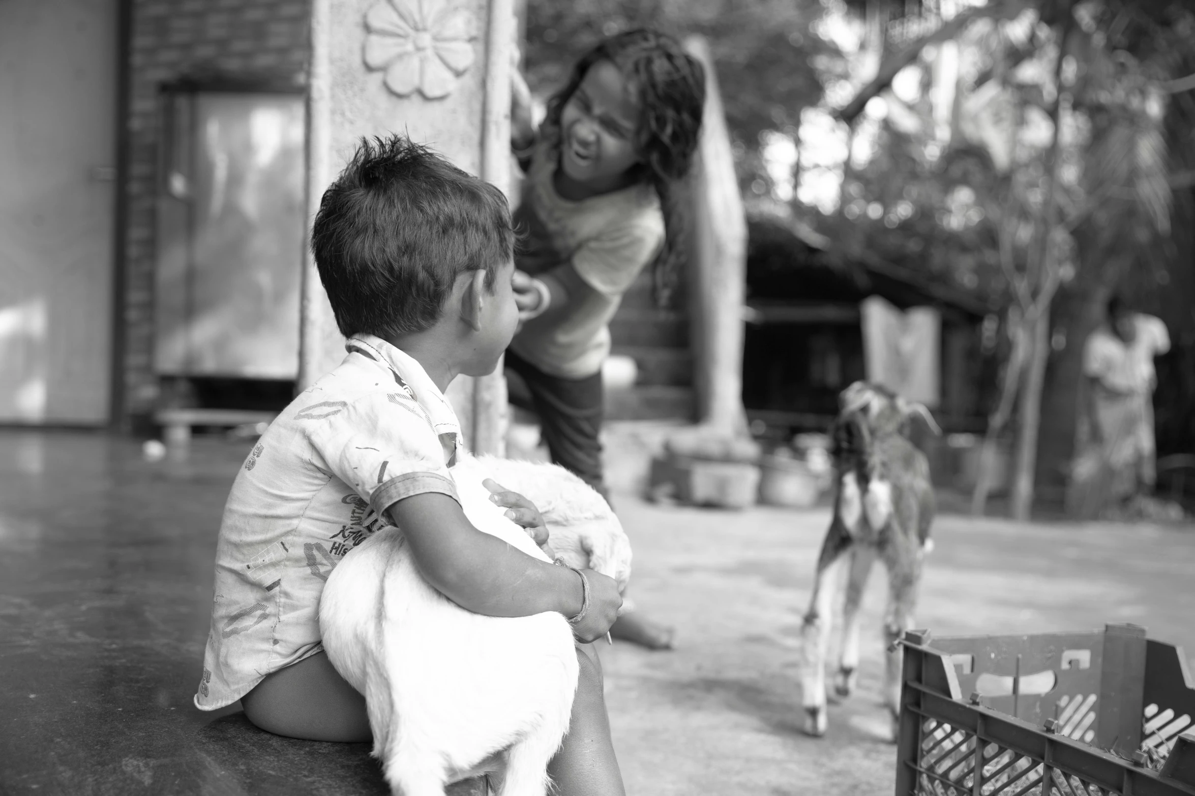 a young child and woman play in a yard