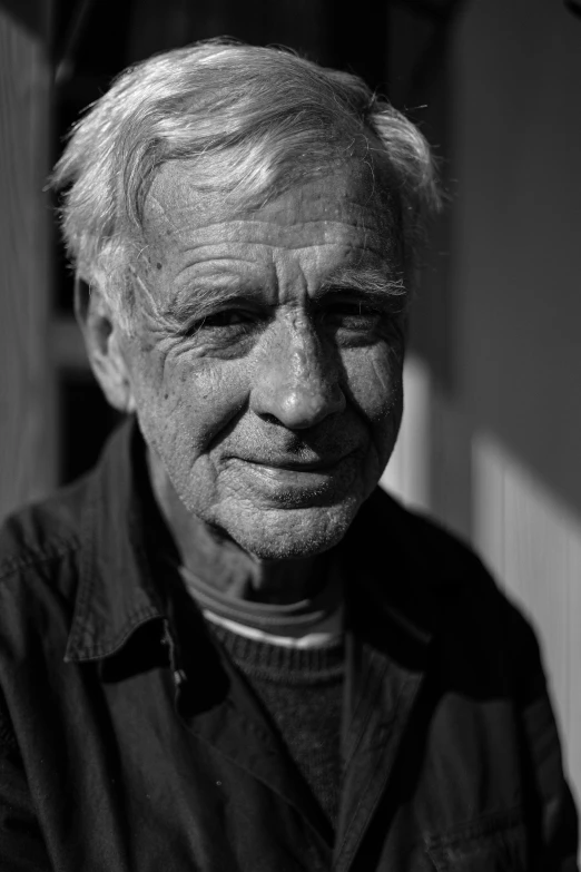 an old man wearing a dark shirt and black shirt with a collared shirt