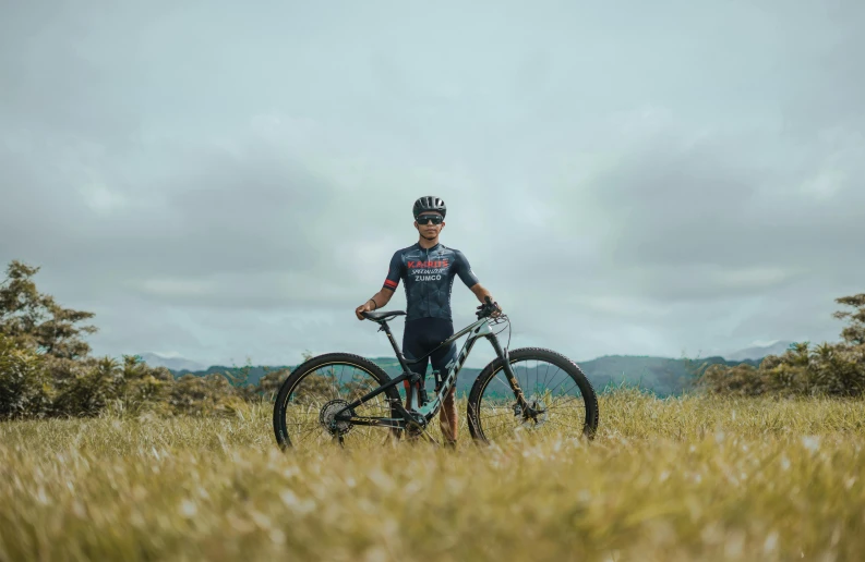 a man in a bike suit with his bike outside